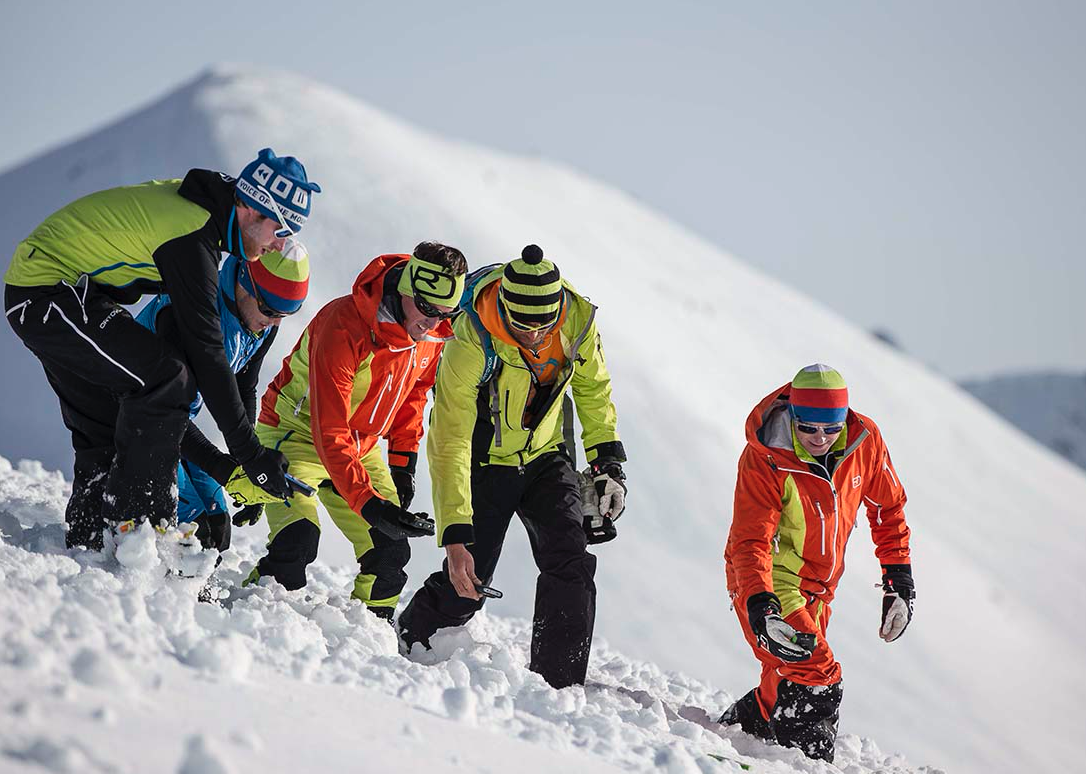 As a crucial life saving tool, Why are avalanche beacons not standardized across the industry?